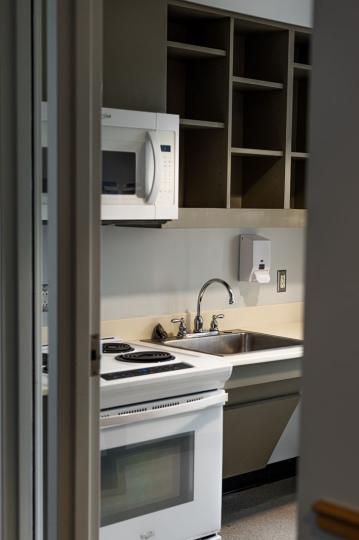 kitchen with microwave, stove, and sink