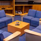 room with four couches facing eachother around a small game table