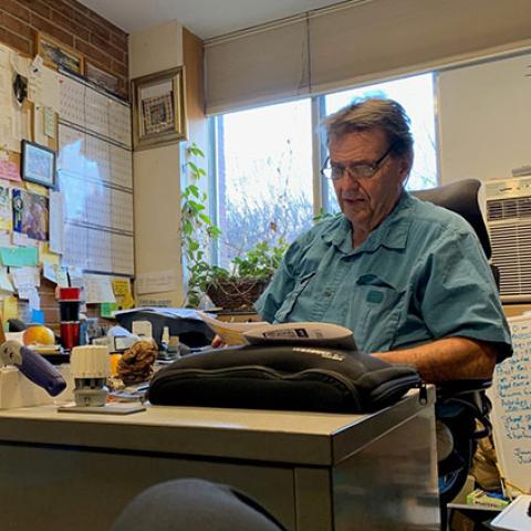 Lou Farino sitting at his desk